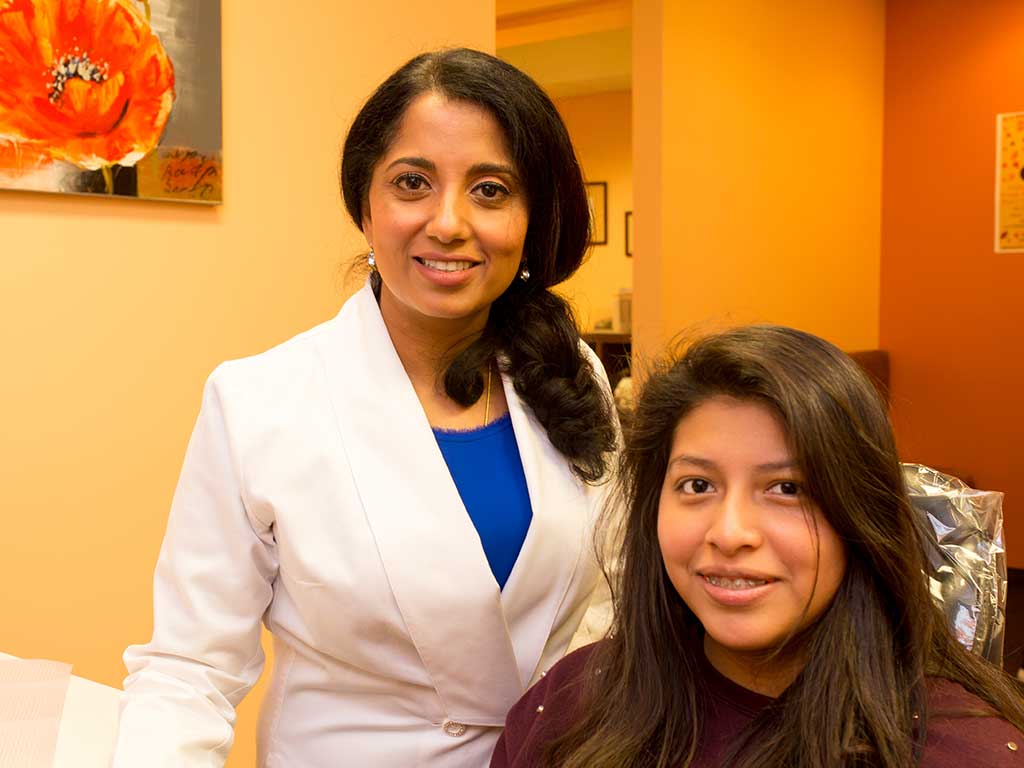 Patient smiles confidently after receiving fixed retainers for lasting results.